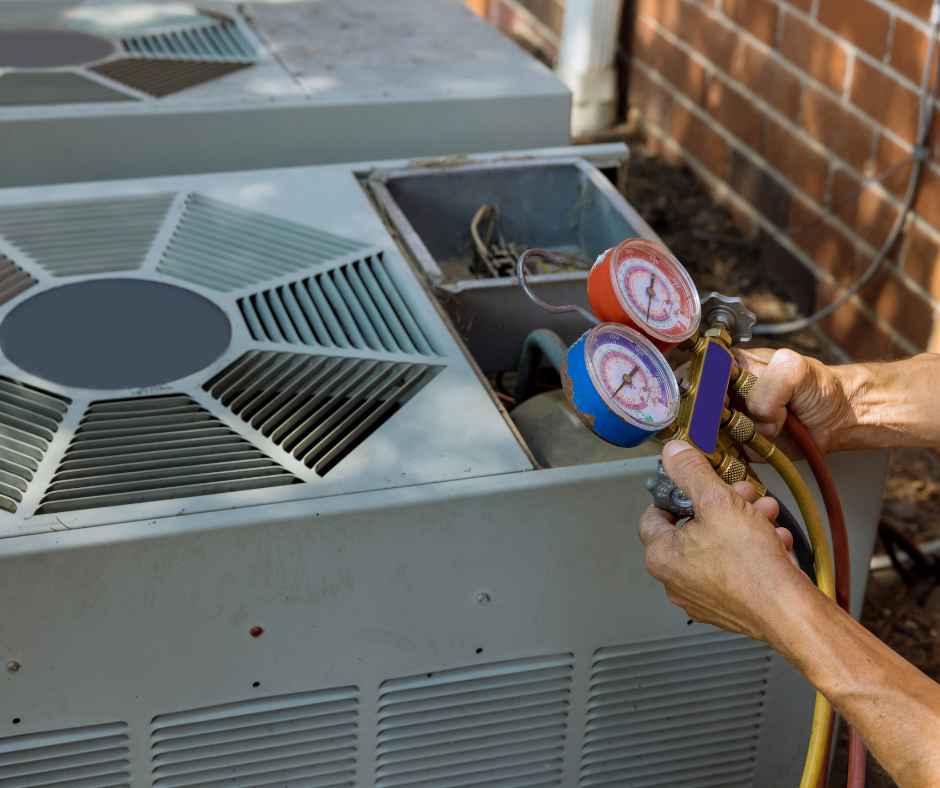 A technician working on an air conditioner