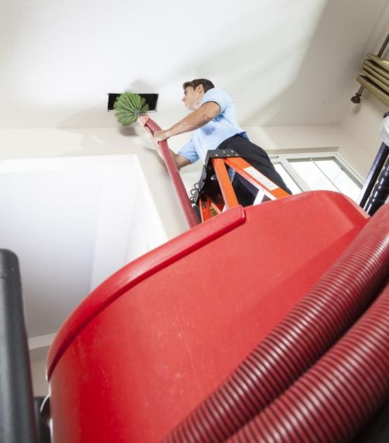 Technician Cleaning Air Duct